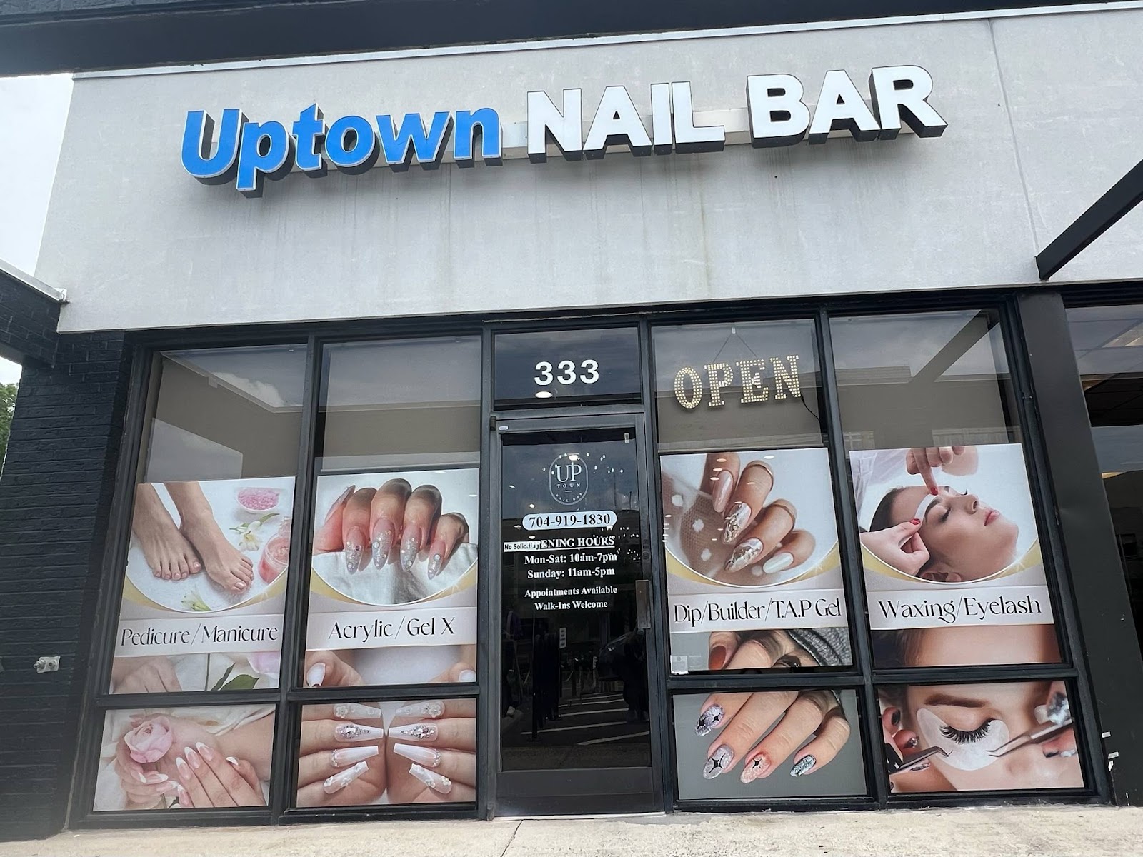 Uptown Nail Bar logo